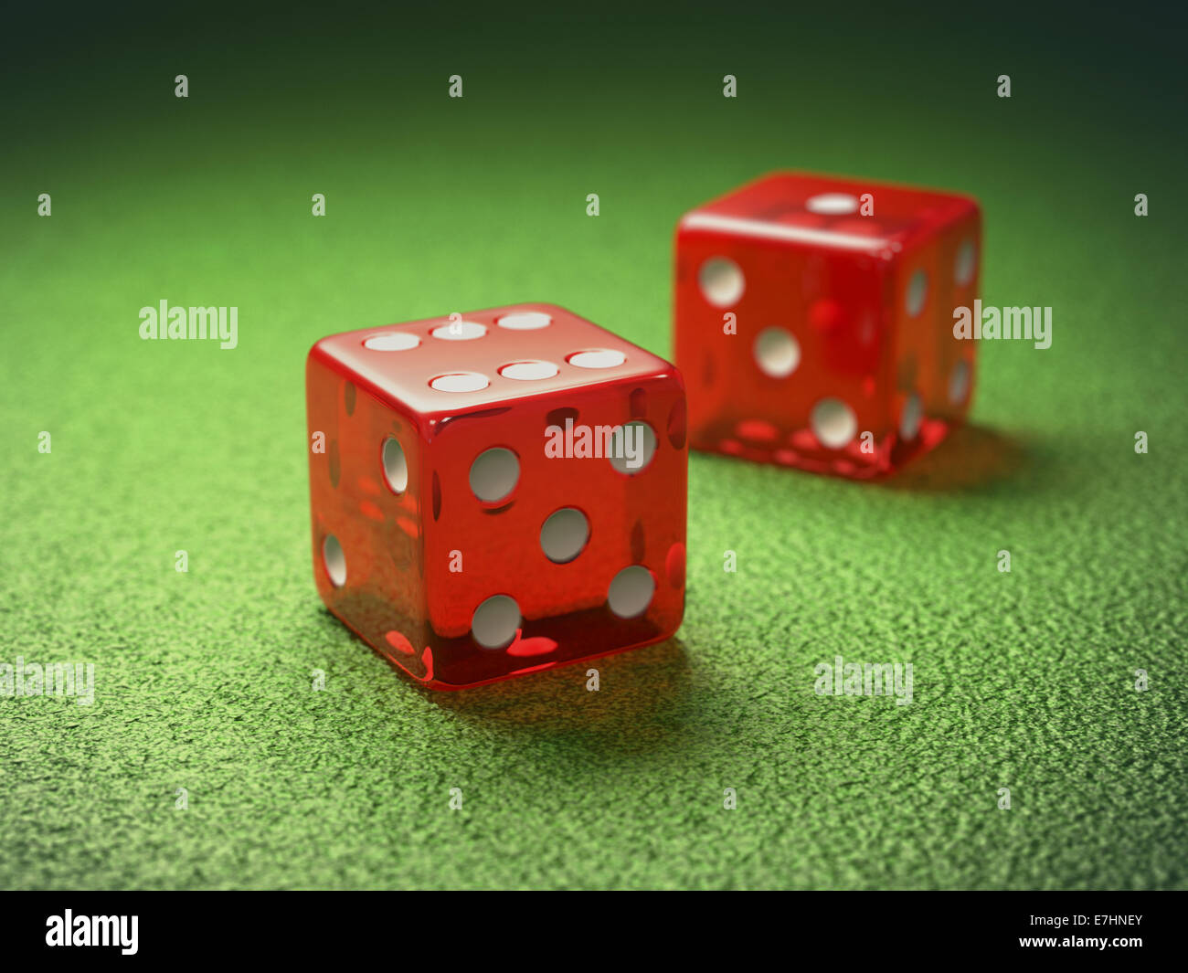 Red dice on green table gambling. Clipping path included. Stock Photo