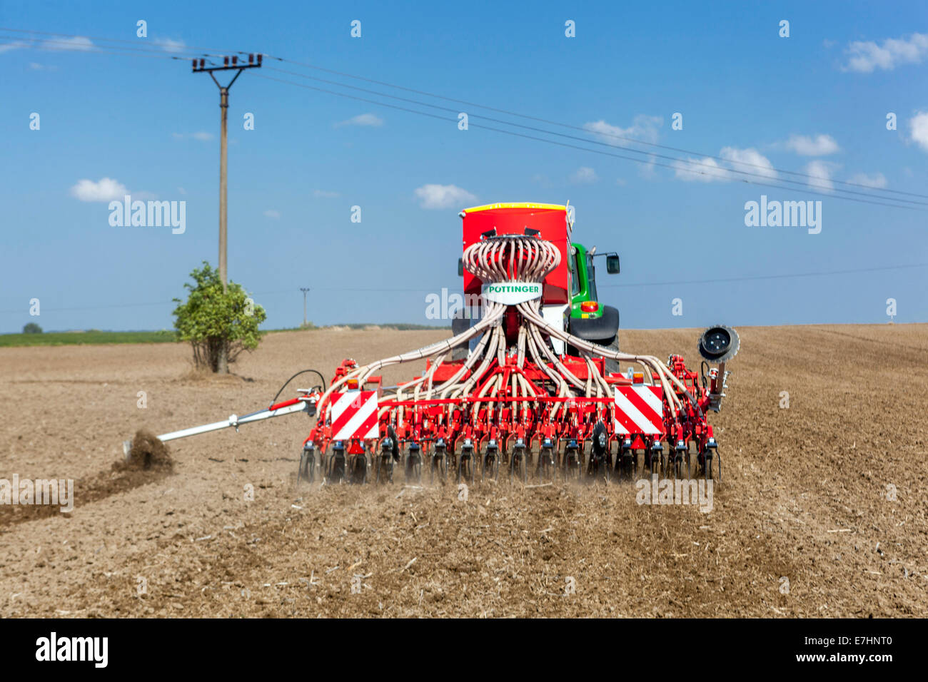 Seed Drill sowing wheat on a field Czech Republic farmer seeder agricultural machinery, Seeding machine Stock Photo