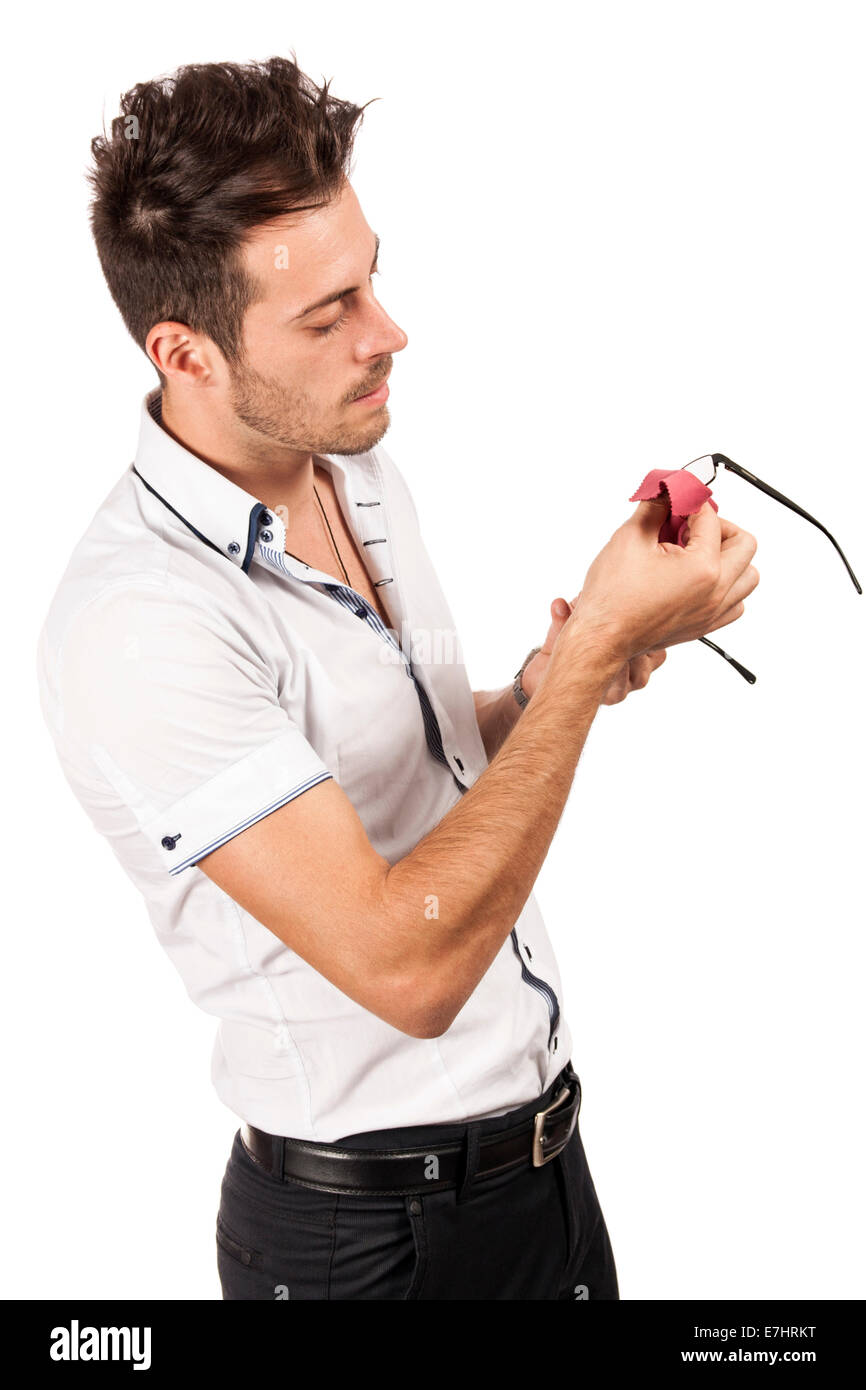 Handsome man cleaning glasses with a piece of tissue, isolated over white background Stock Photo