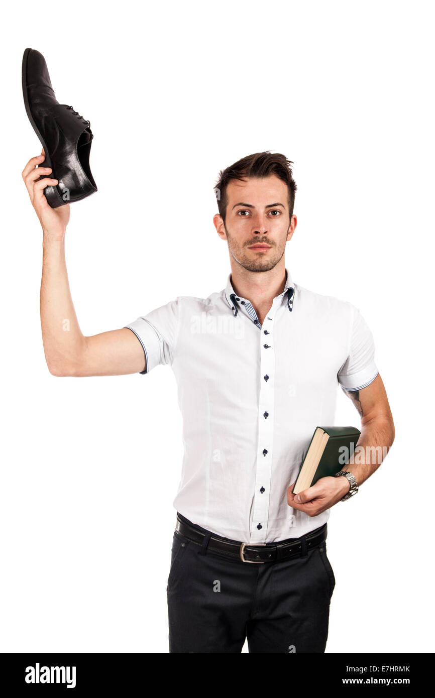 Man showing a shoe and the other hand holding a book isolated on white Stock Photo