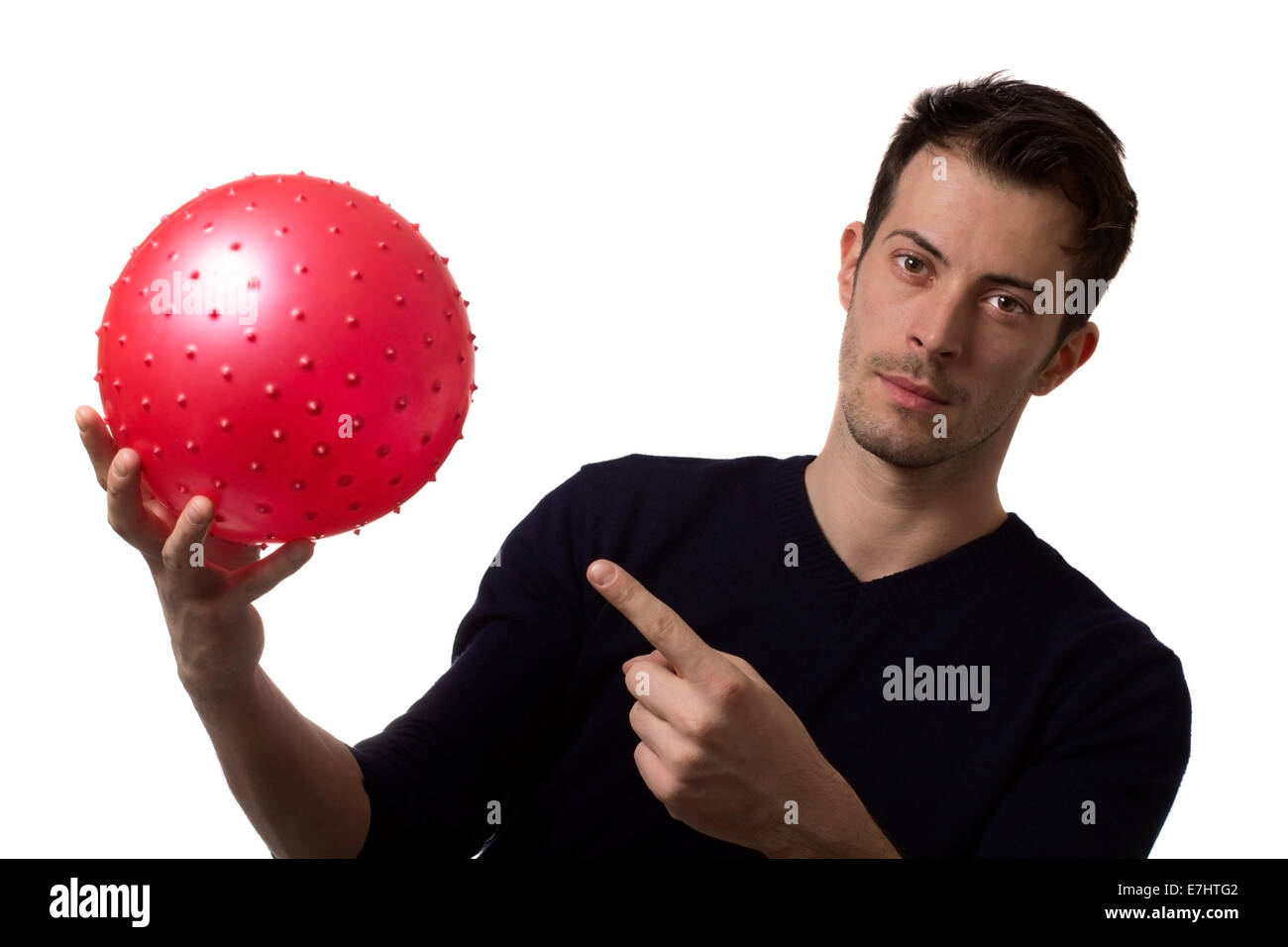 man pointing fingers to a red ball isolated on white Stock Photo