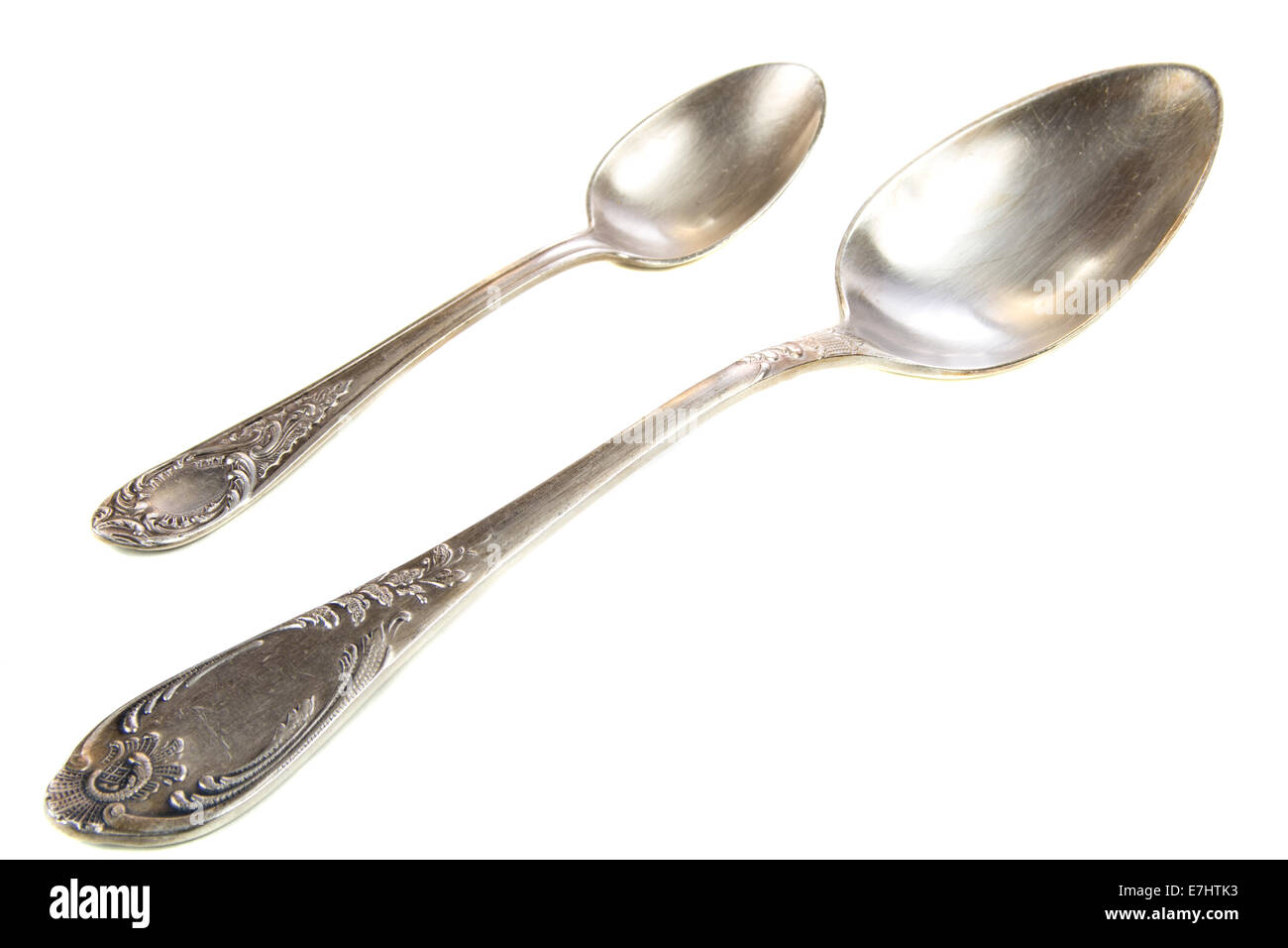 Pair of old silver spoons isolated on white background Stock Photo
