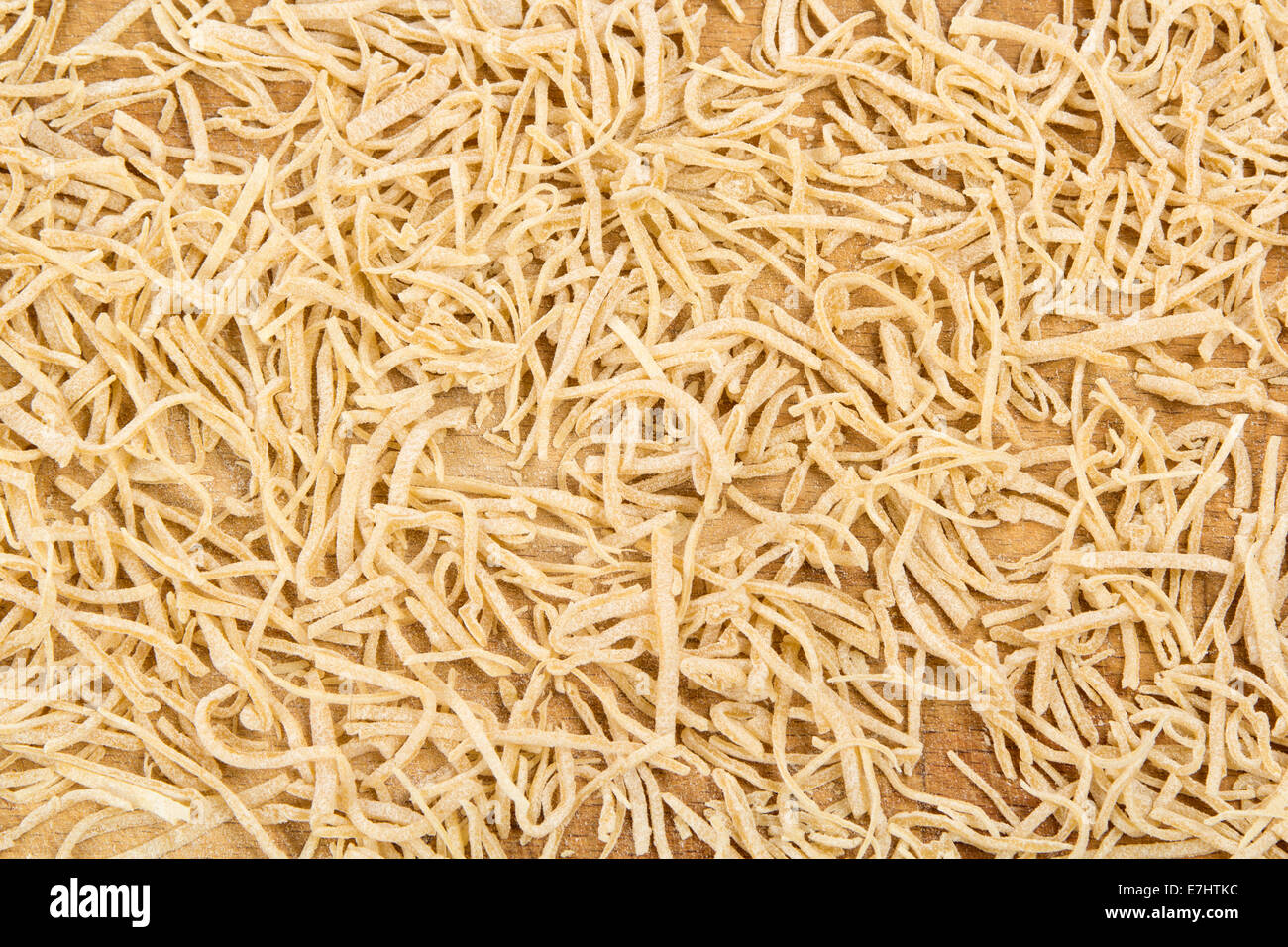 Scattered short dried noodles from above Stock Photo