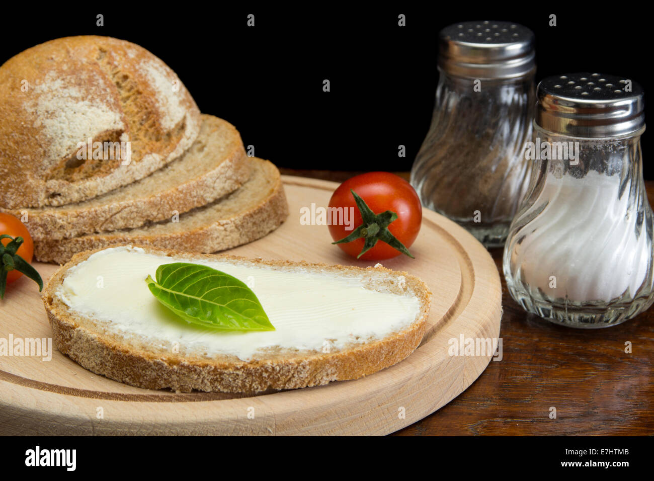 Close up image of spreading cream cheese on pumpernickel bread Stock Photo