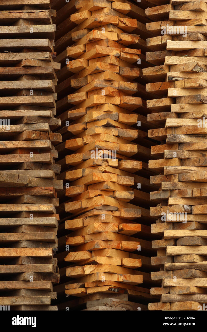 Stacked cut boards are stacked for sale at an outdoor lumber yard in