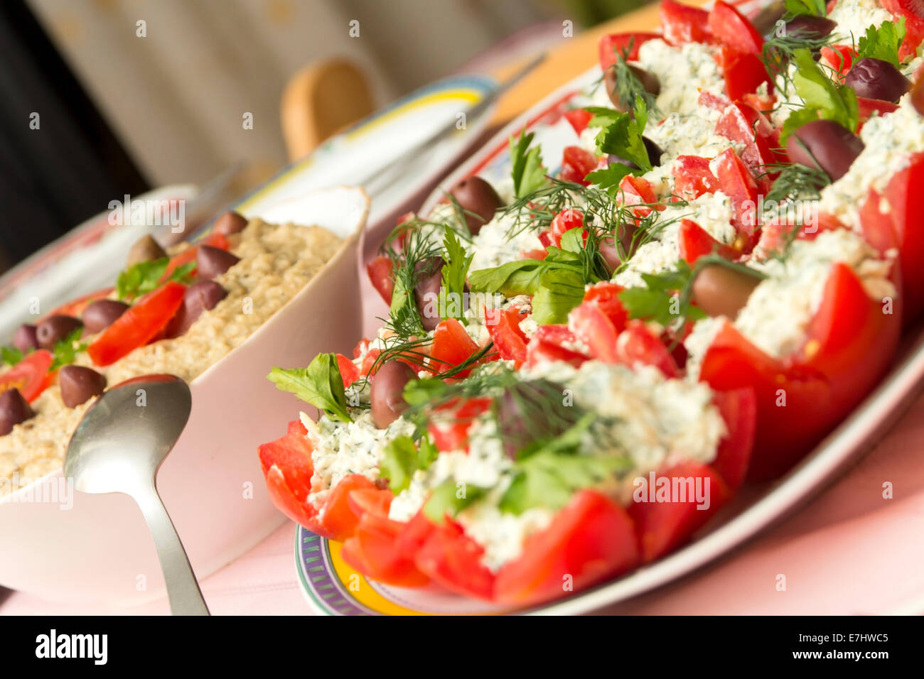 Close-up of stuffed tomatoes with cheese and eggplant salad on table Stock Photo