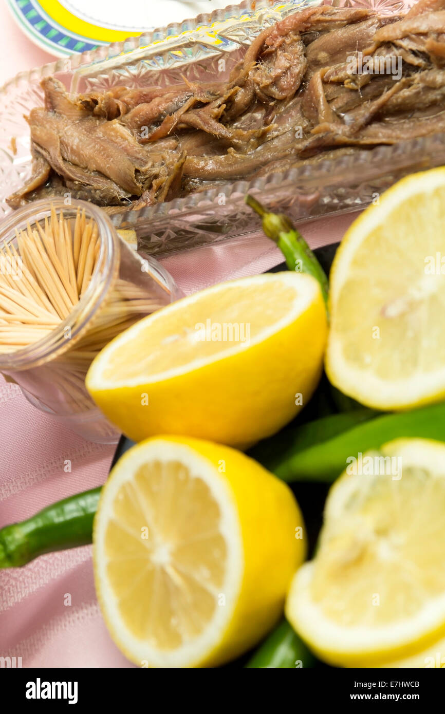 Marinated anchovies with lemons,toothpicks and chili peppers Stock Photo