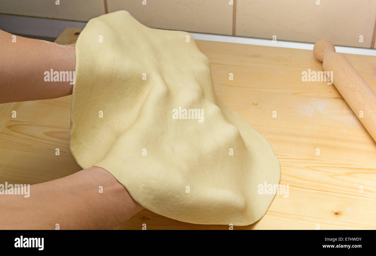 Close-up of hands of the cook kneading dough pizza Stock Photo