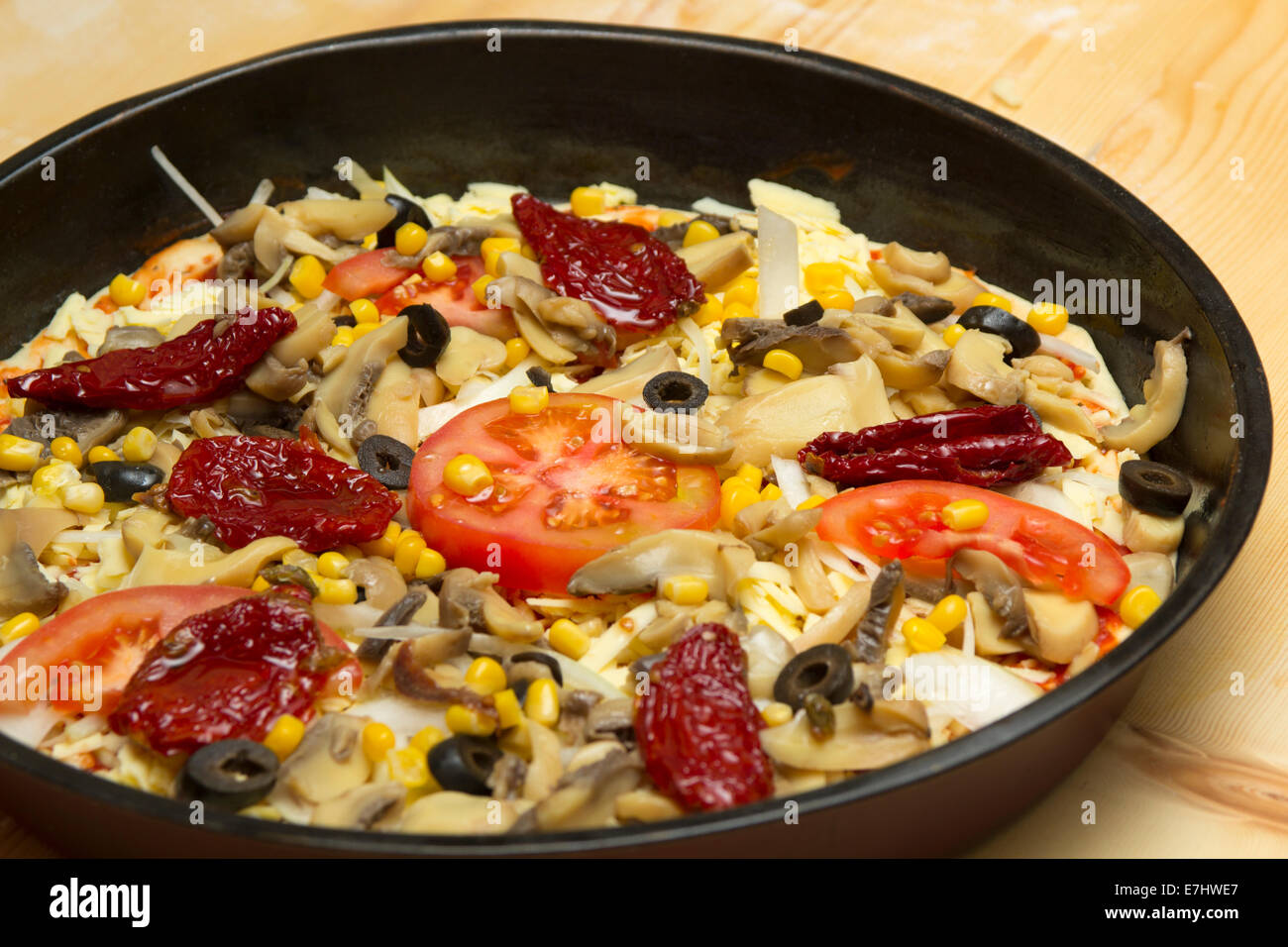 Close-up of vegetarian unprepared pizza with tomatoes, mushrooms and meat Stock Photo