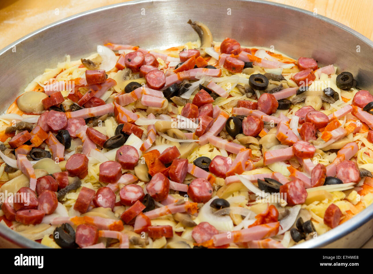 Close-up of unprepared pizza with tomatoes, mushrooms and meat Stock Photo