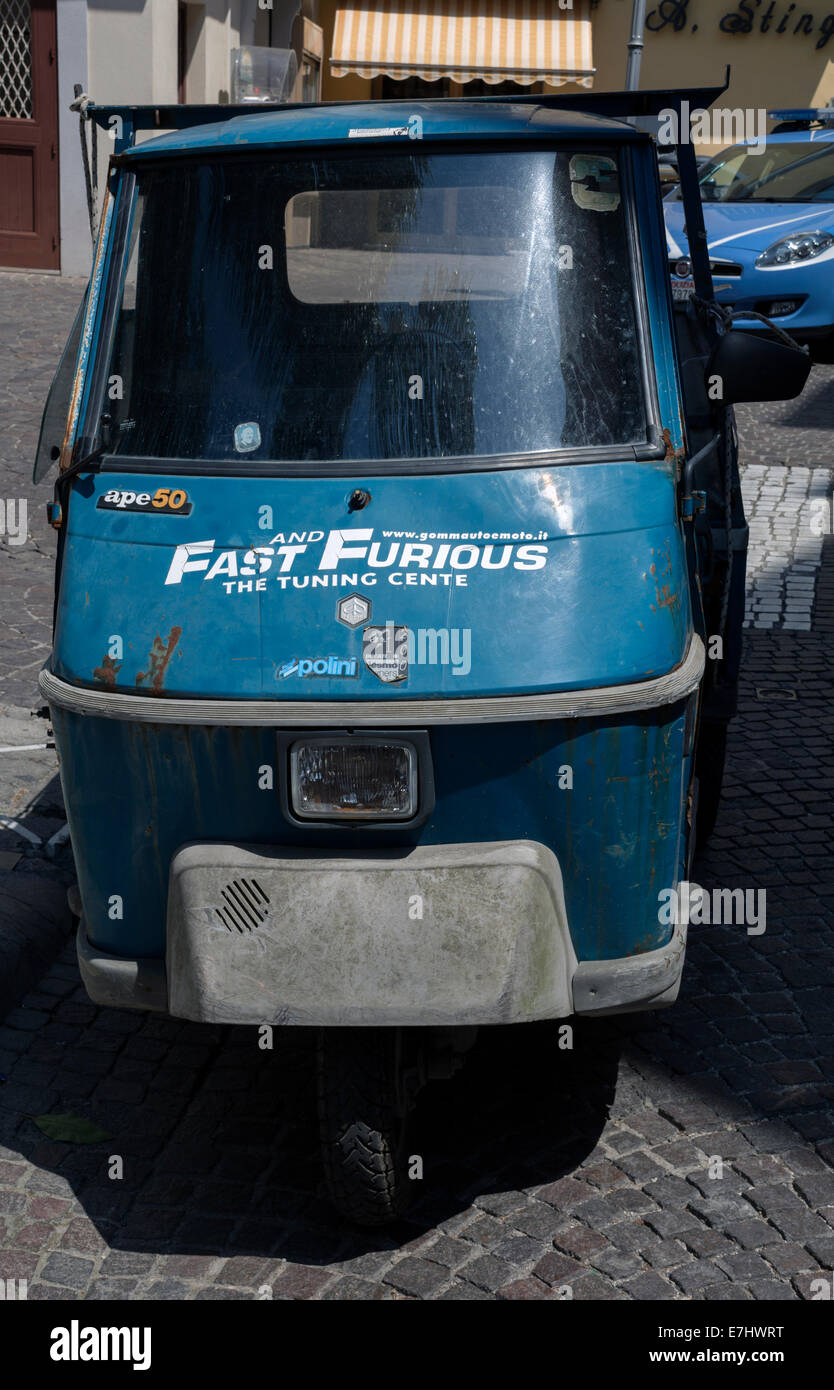 A rickety three wheeler pickup van with 'Fast & Furious' adverising decal for tune ups. Stock Photo