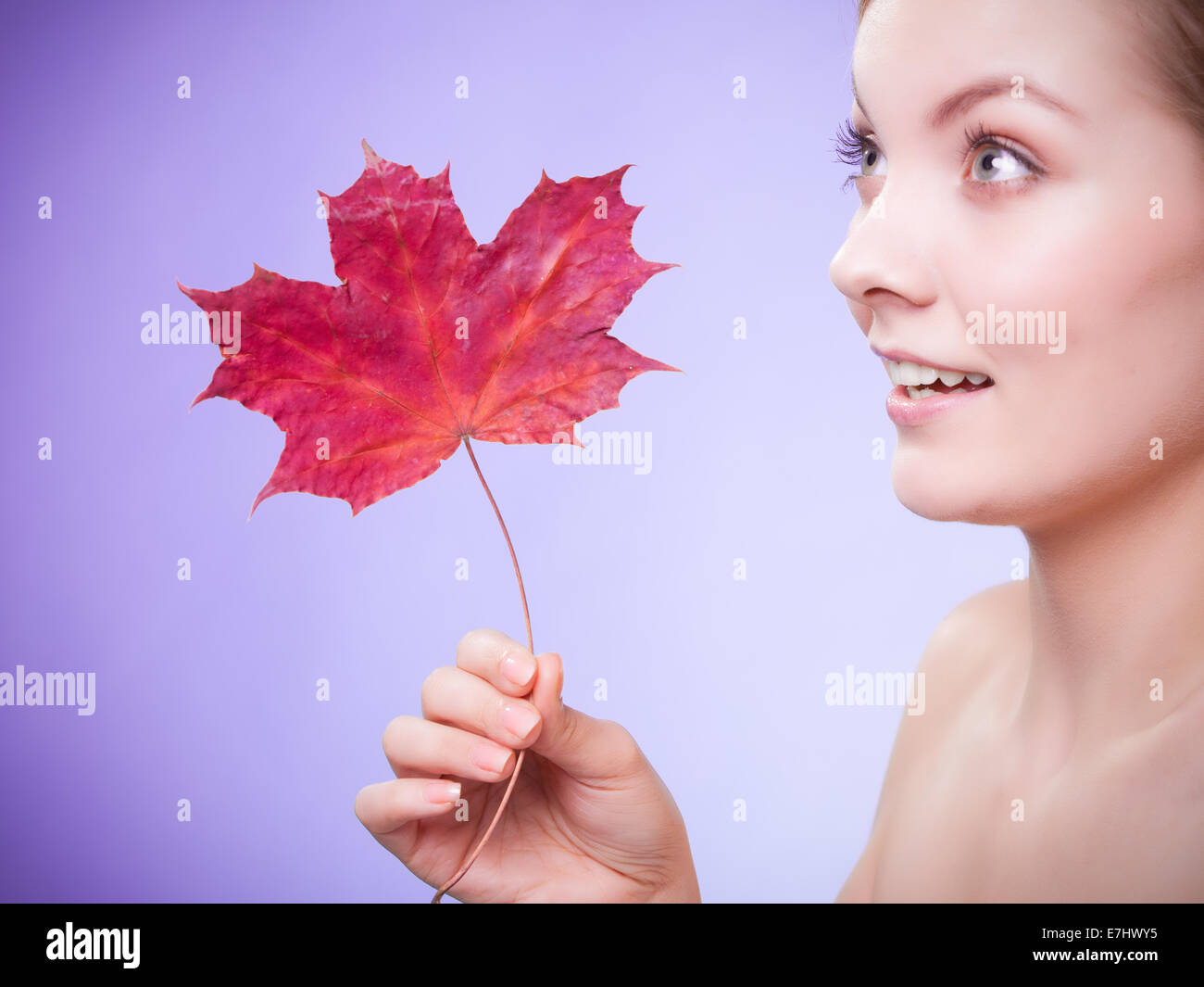 Skin care. Face of young woman girl with red maple leaf Stock Photo - Alamy