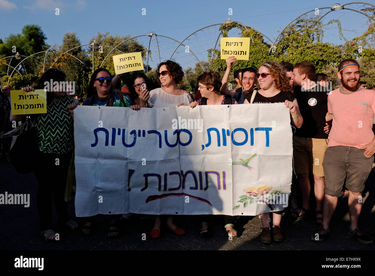 Young religious Jewish women hold a placard in Hebrew which reads "Religious, Straight and Supporters" during the annual Jerusalem gay pride parade as part of the international observance of LGBT Pride Month. Israel Stock Photo