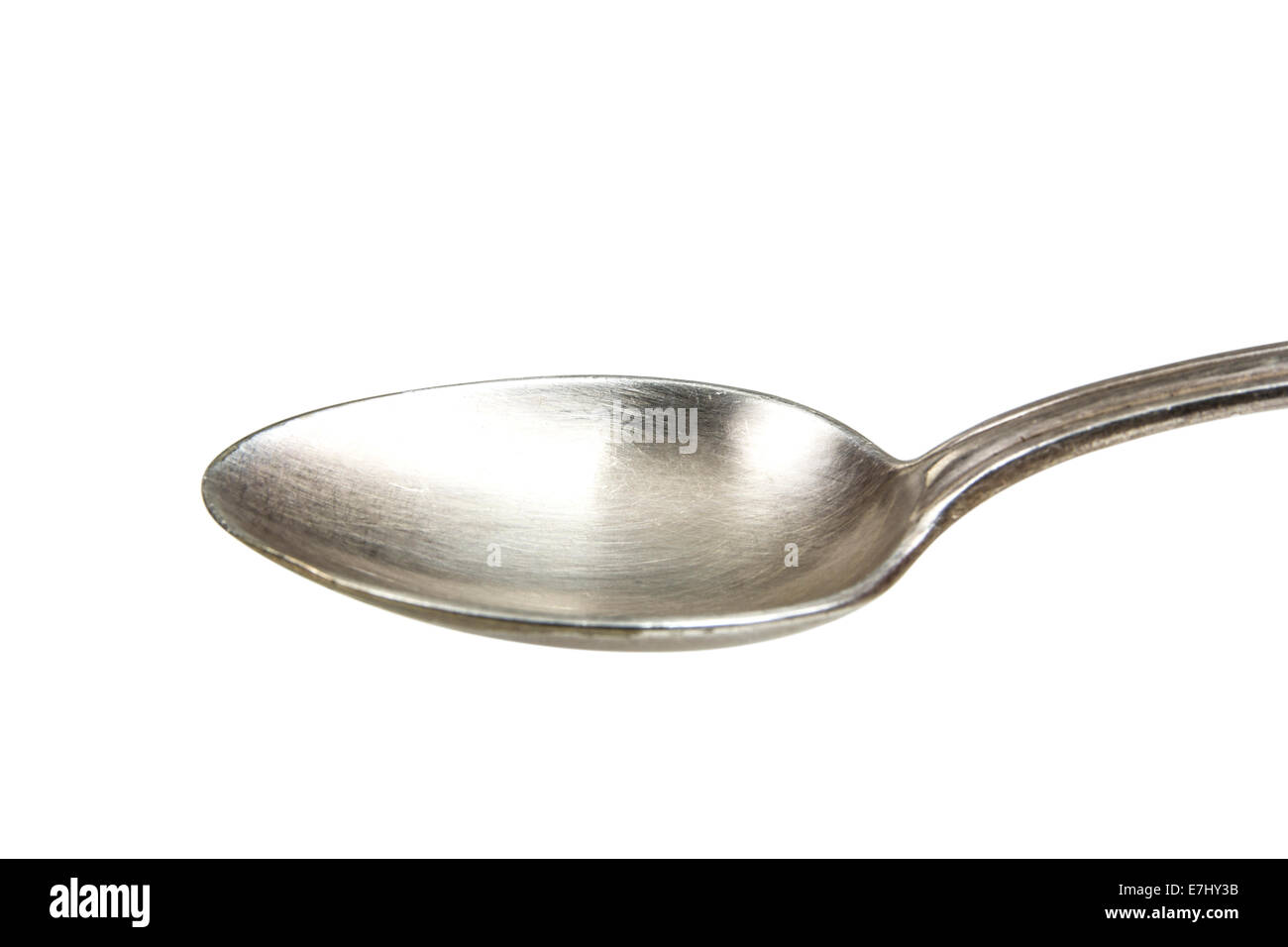 A silver spoon against a white background. Clipping path included for easy extraction. Stock Photo