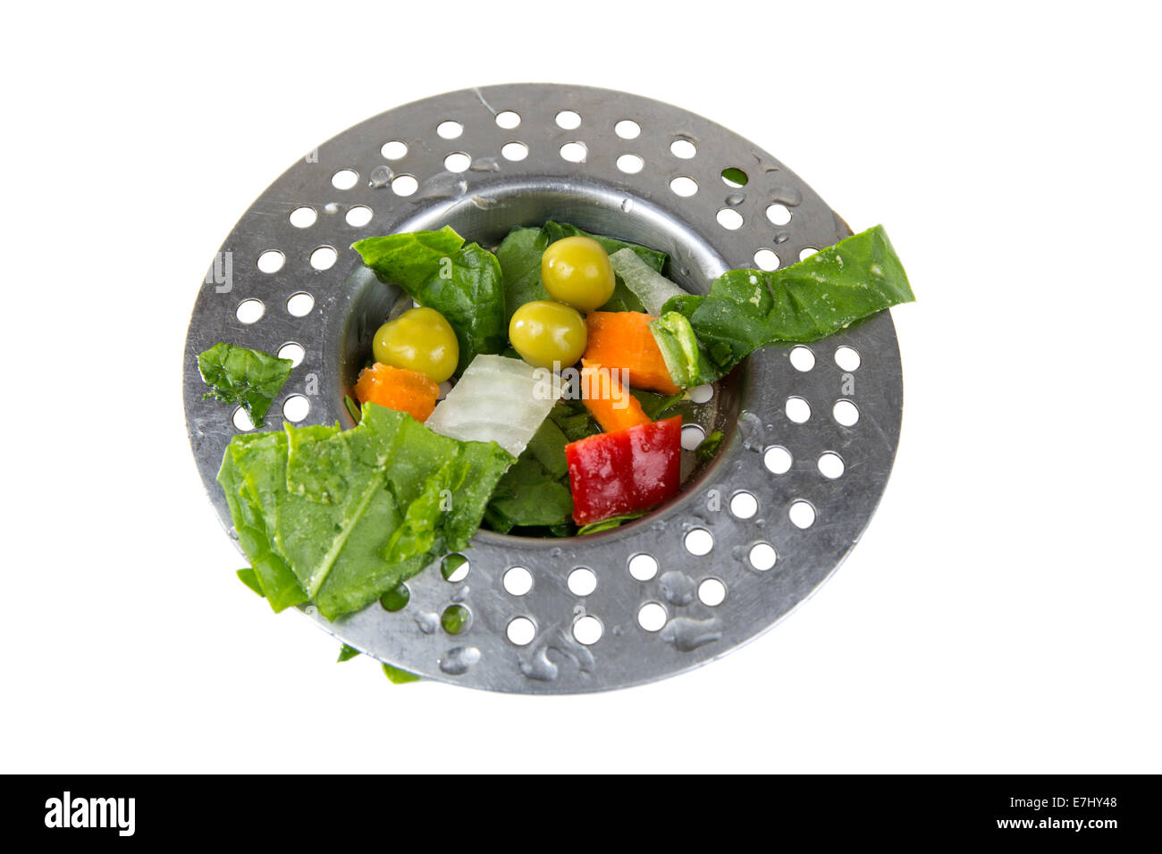 Drain sink full of old vegetables isolated over white background Stock Photo