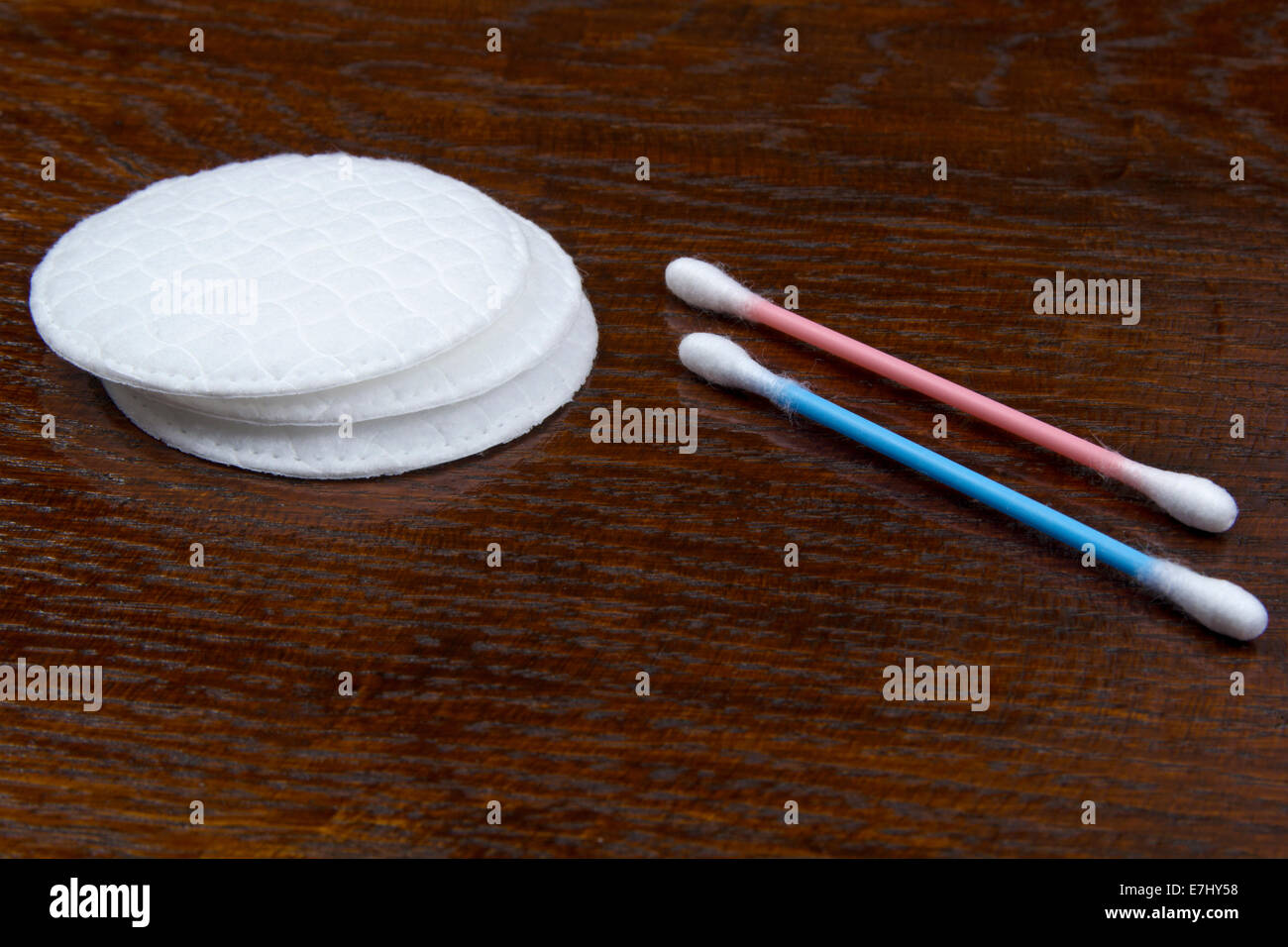 Cotton swabs and sticks on wood background Stock Photo