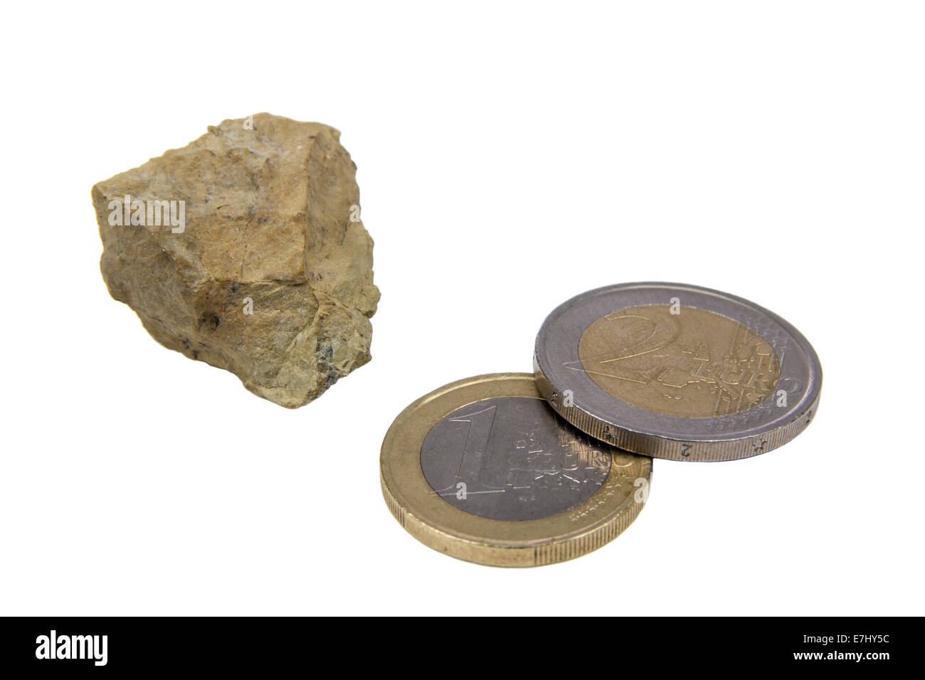 One stone and two coins isolated over white background Stock Photo
