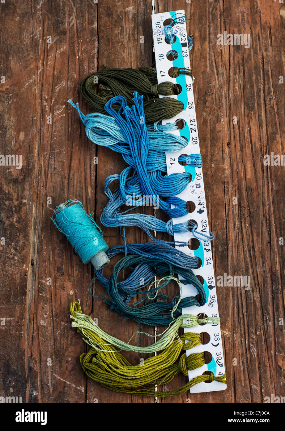 Different Blue Threads set of threads of different types,colors and lengths on wooden ...