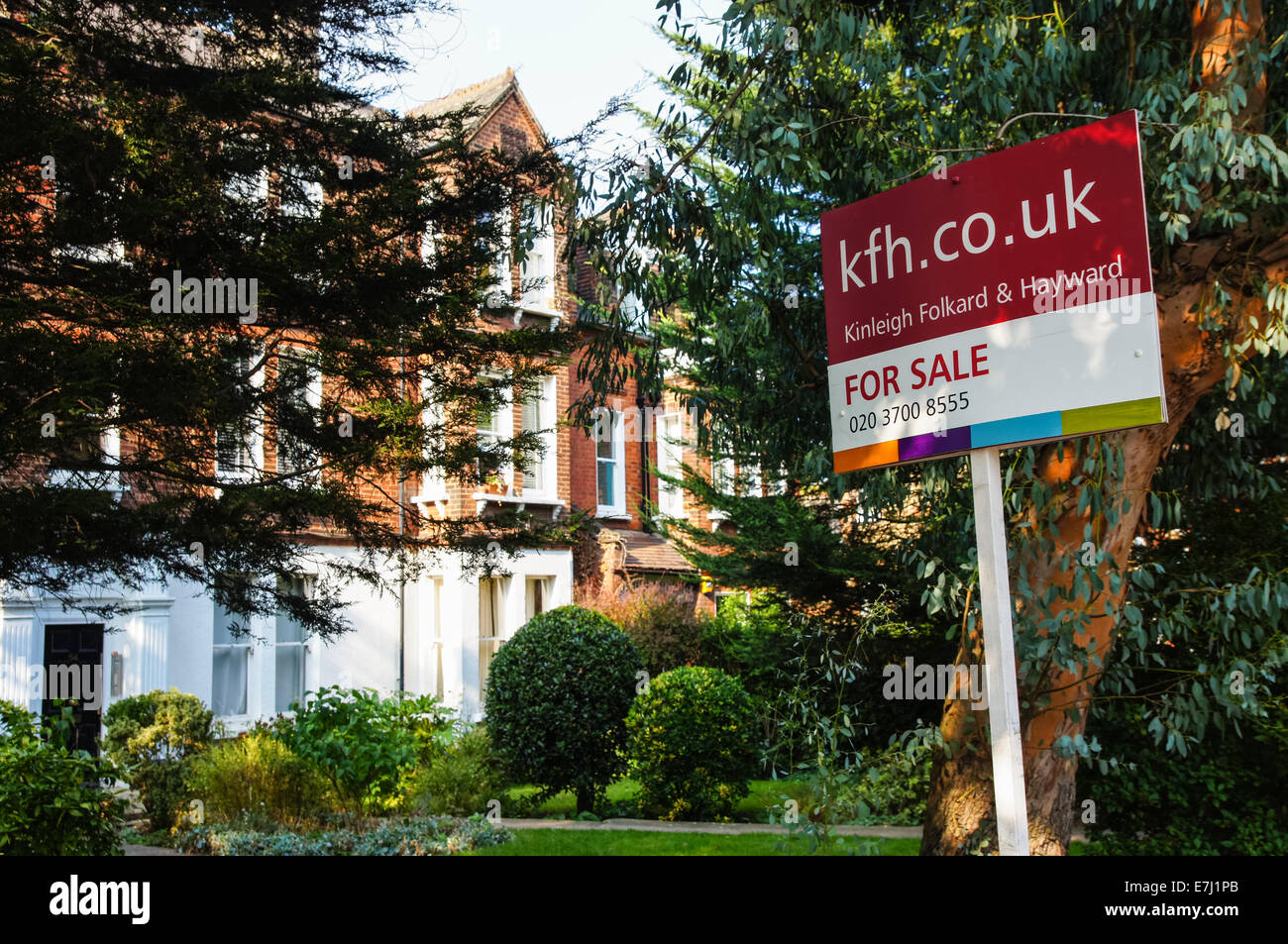 A real estate sign For Sale outside terraced houses in South London England United Kingdom UK Stock Photo