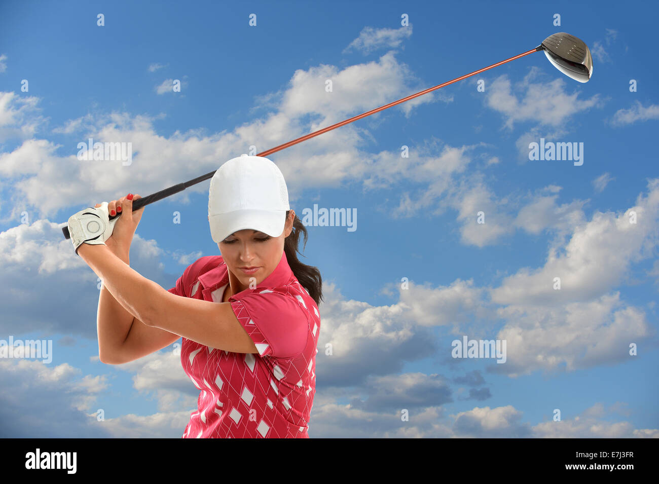 Female golfer swinging golf driver during sunny day Stock Photo Alamy