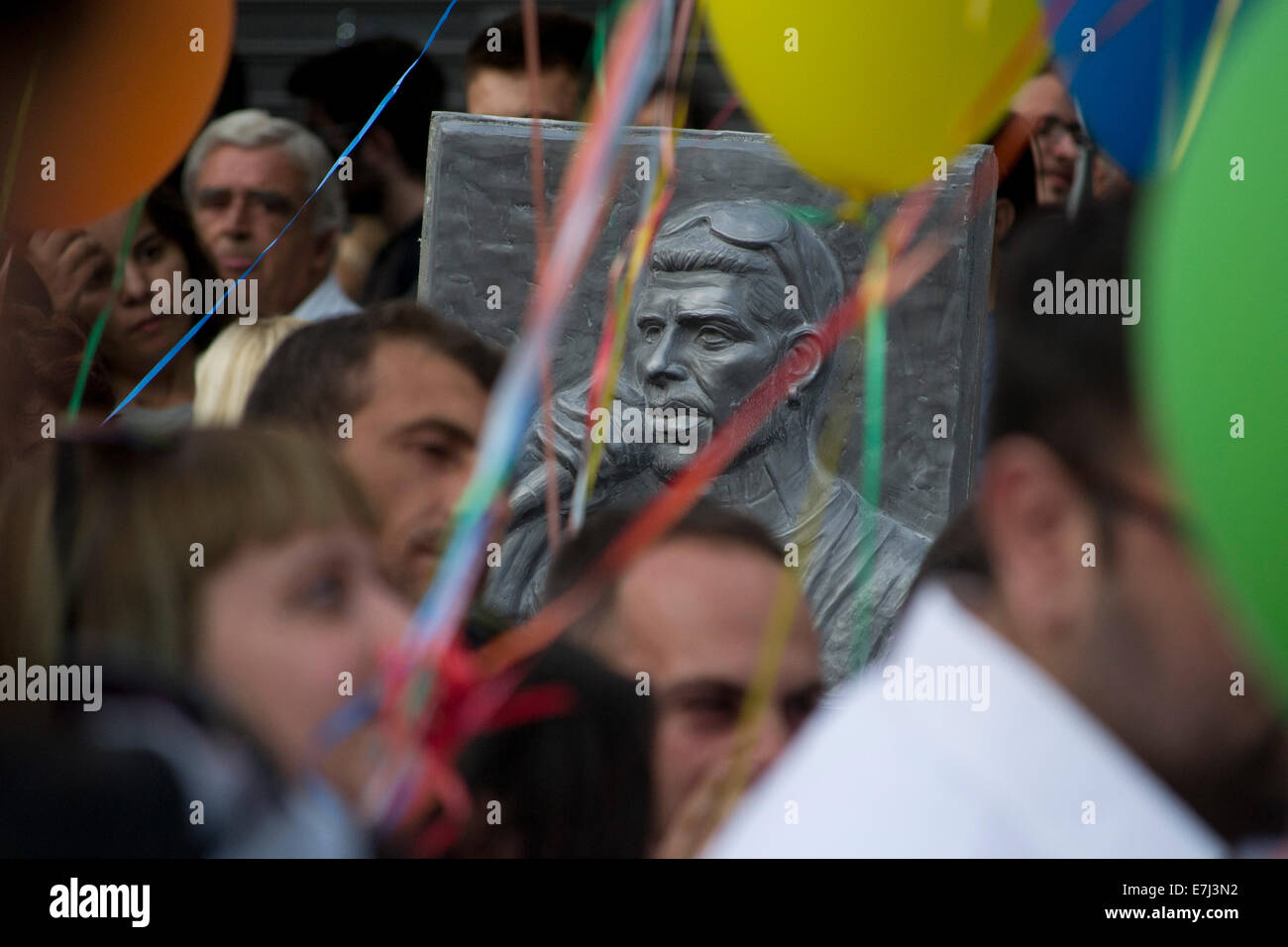 Athens, Greece. 18th September, 2014. A monument in honor of rapper Pavlos Fyssas stands among protesters at the place  his was murdered a year ago by a member of the neonazi, Golden Dawn party. Athens, Greece, September 18, 2014.  Credit:  Nikolas Georgiou / Alamy Live News Stock Photo