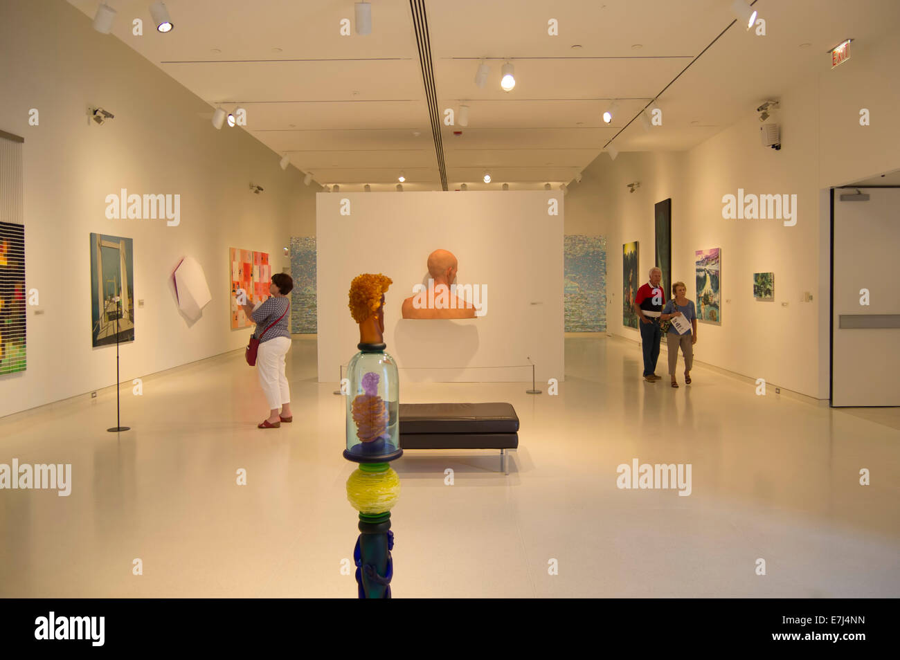 People wander around in an art museum gallery. Stock Photo