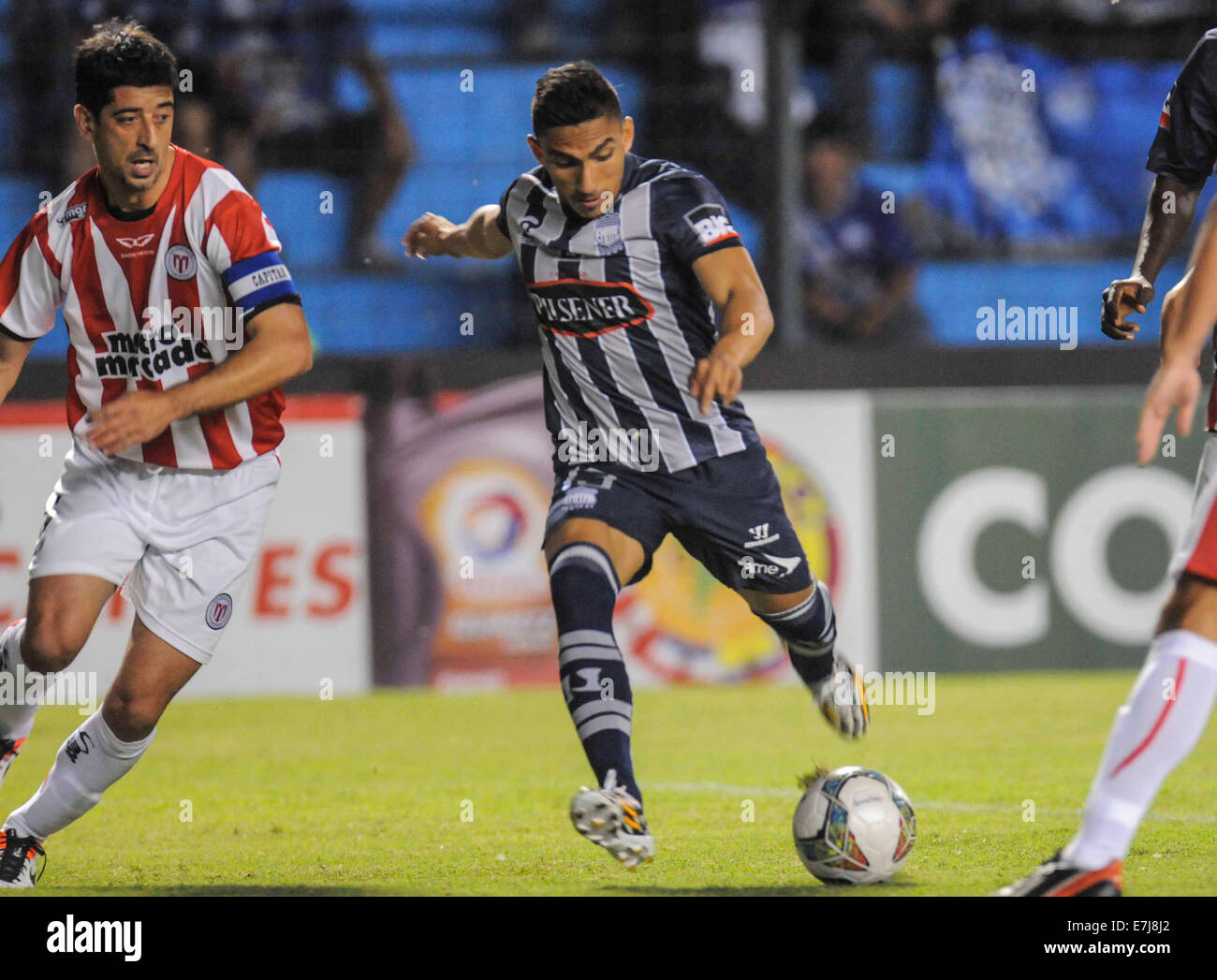 Guayaquil, Ecuador. 18th Sep, 2014. Angel Mena (R) of Ecuador's Emelec, vies for the ball with Cristian Gonzalez (L) of Uruguay's River Plate, during a match of the South American Cup, held in the Capwell Stadium, in Guayaquil, Ecuador, on Sept. 18, 2014. © Str/Xinhua/Alamy Live News Stock Photo