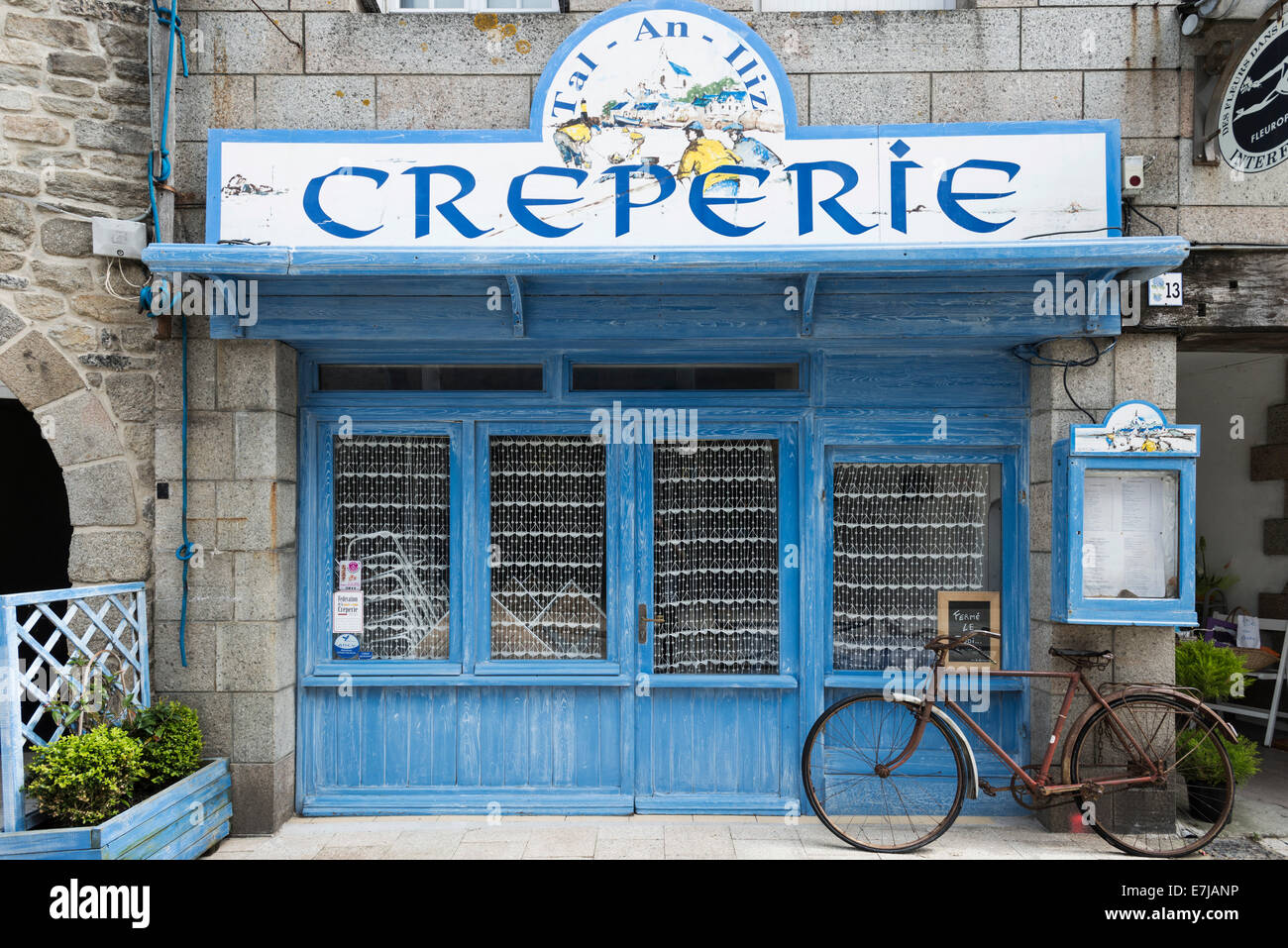 Old bicycle in front of a Creperie, Roscoff, Brittany, France Stock Photo