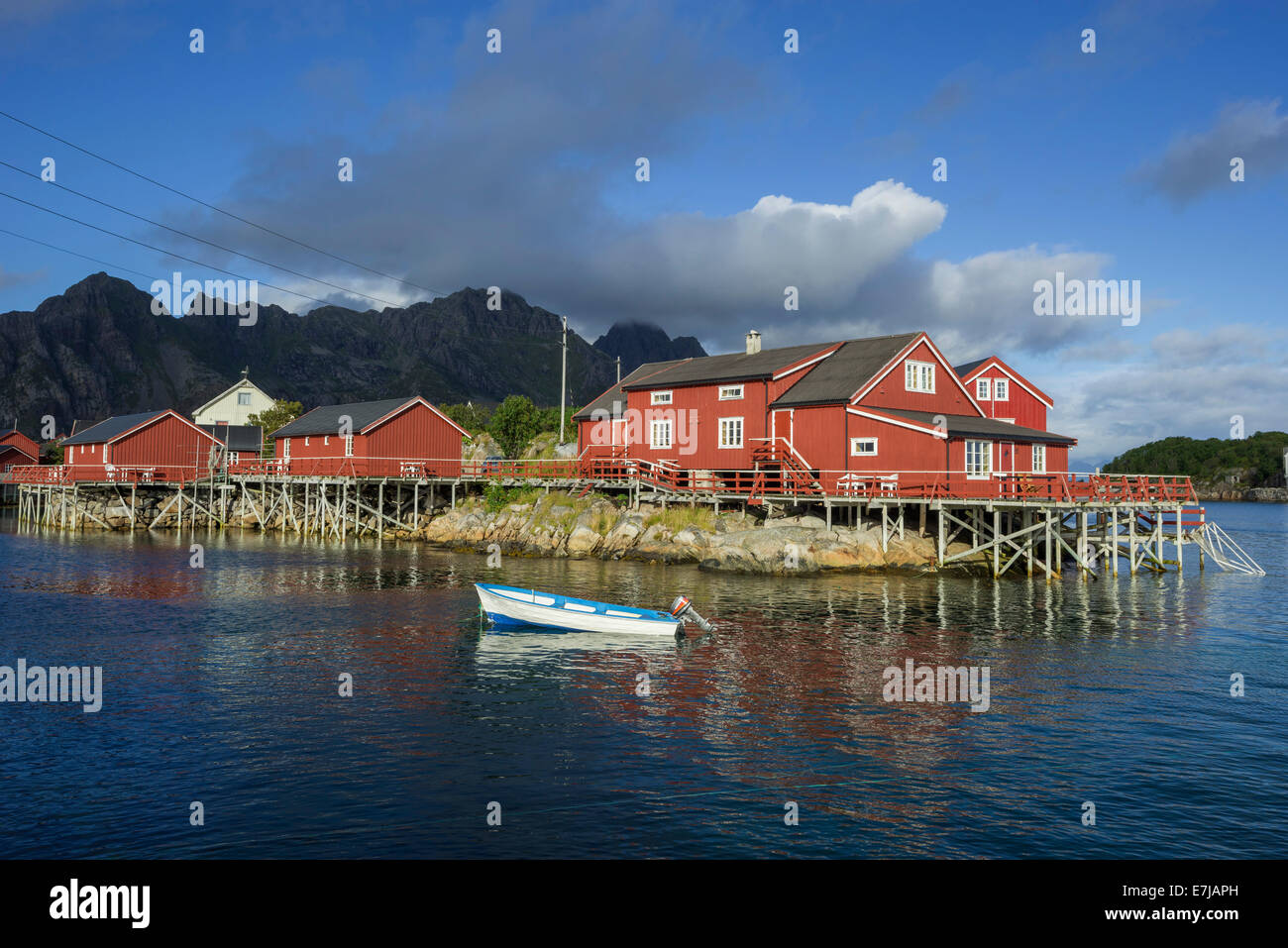 Rorbuer fishermen's cabins with a small motor boat, Henningsvær, Lofoten, Nordland, Norway Stock Photo