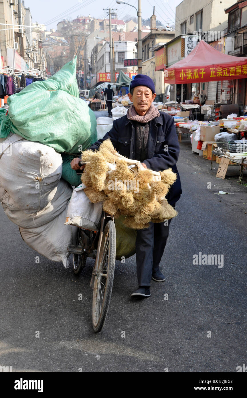 Man transporting goods with a bicycle, Qingdao, Shandong province, China Stock Photo