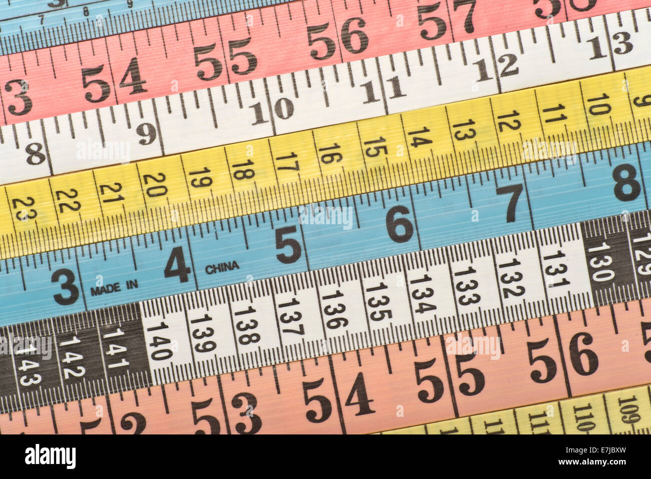 Various colourful measuring tapes Stock Photo
