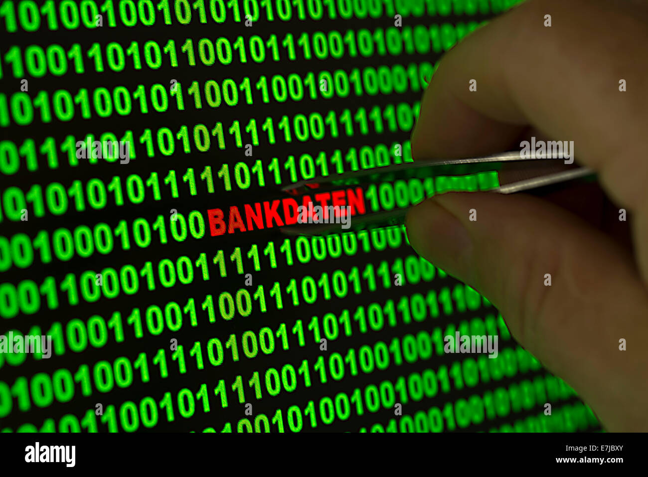 Hand reaching for the word 'Bankdaten', German for 'Banking information' with tweezers in a binary code Stock Photo