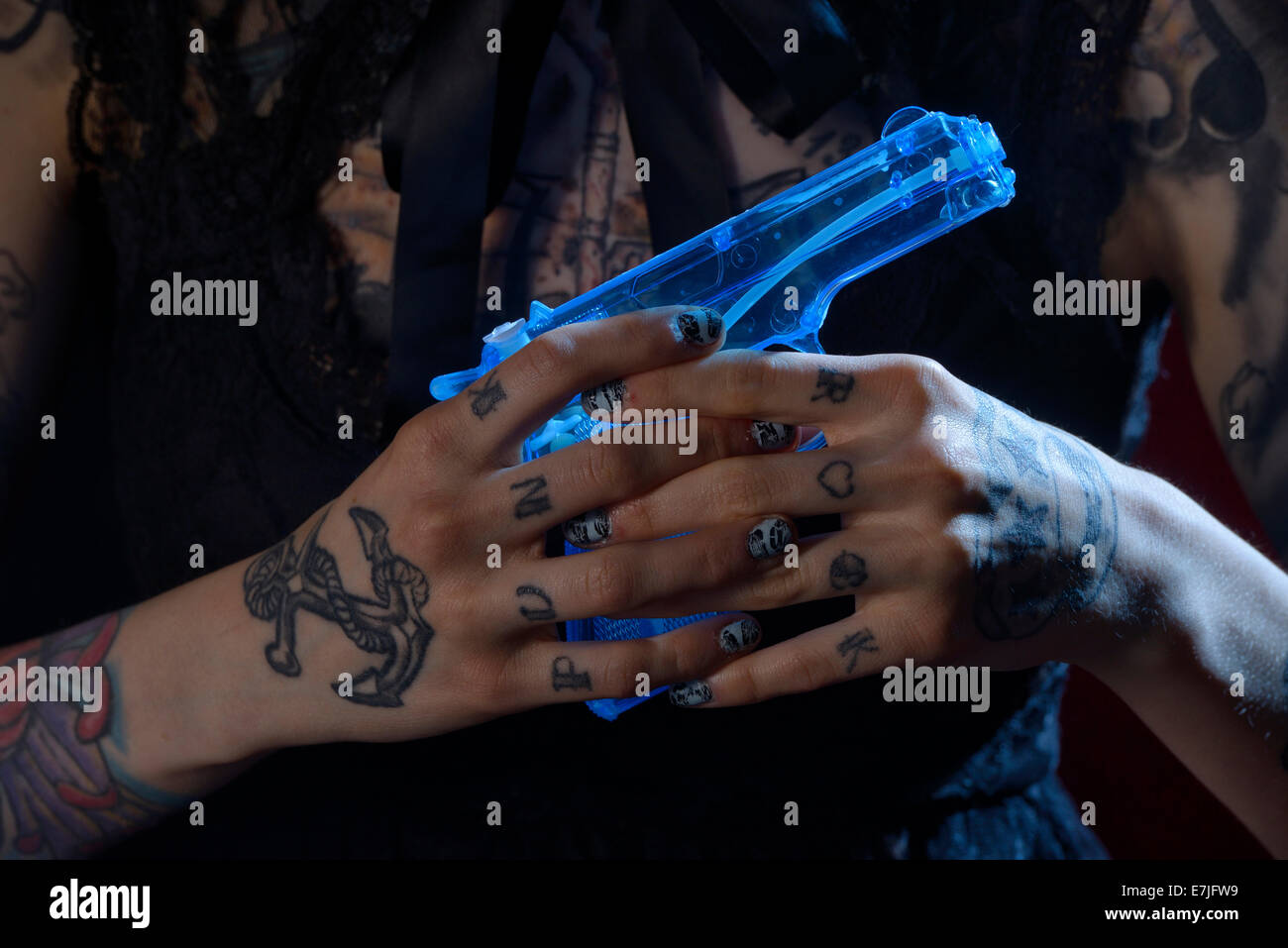 Hands, punk, squirt gun, water pistol, tattoo, hand, girl, dark, fingers, gun, USA Stock Photo