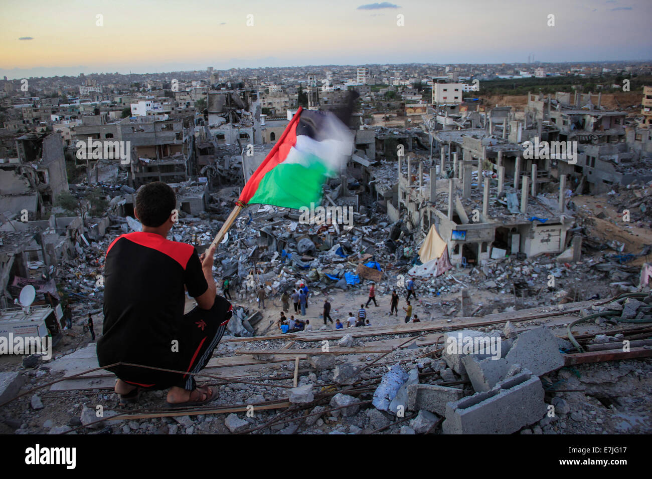 Gaza Strip. 19th Sep, 2014. A Palestinian child sits above the ruins of ...