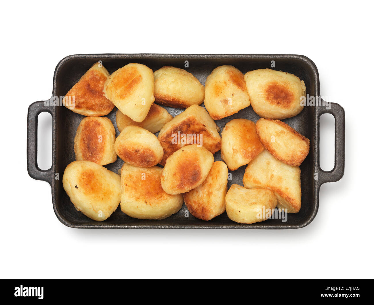 isolated Roast Potato's in roasting dish Stock Photo