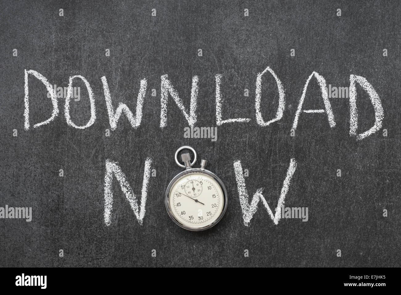download now concept handwritten on chalkboard with vintage precise stopwatch used instead of O Stock Photo