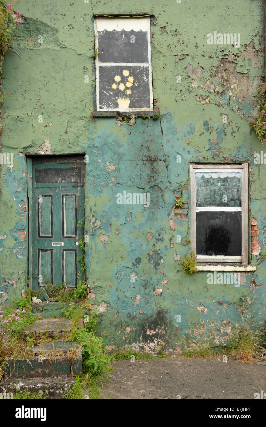 A derelict house decorated with fake painted windows in Limerick, Ireland. Stock Photo