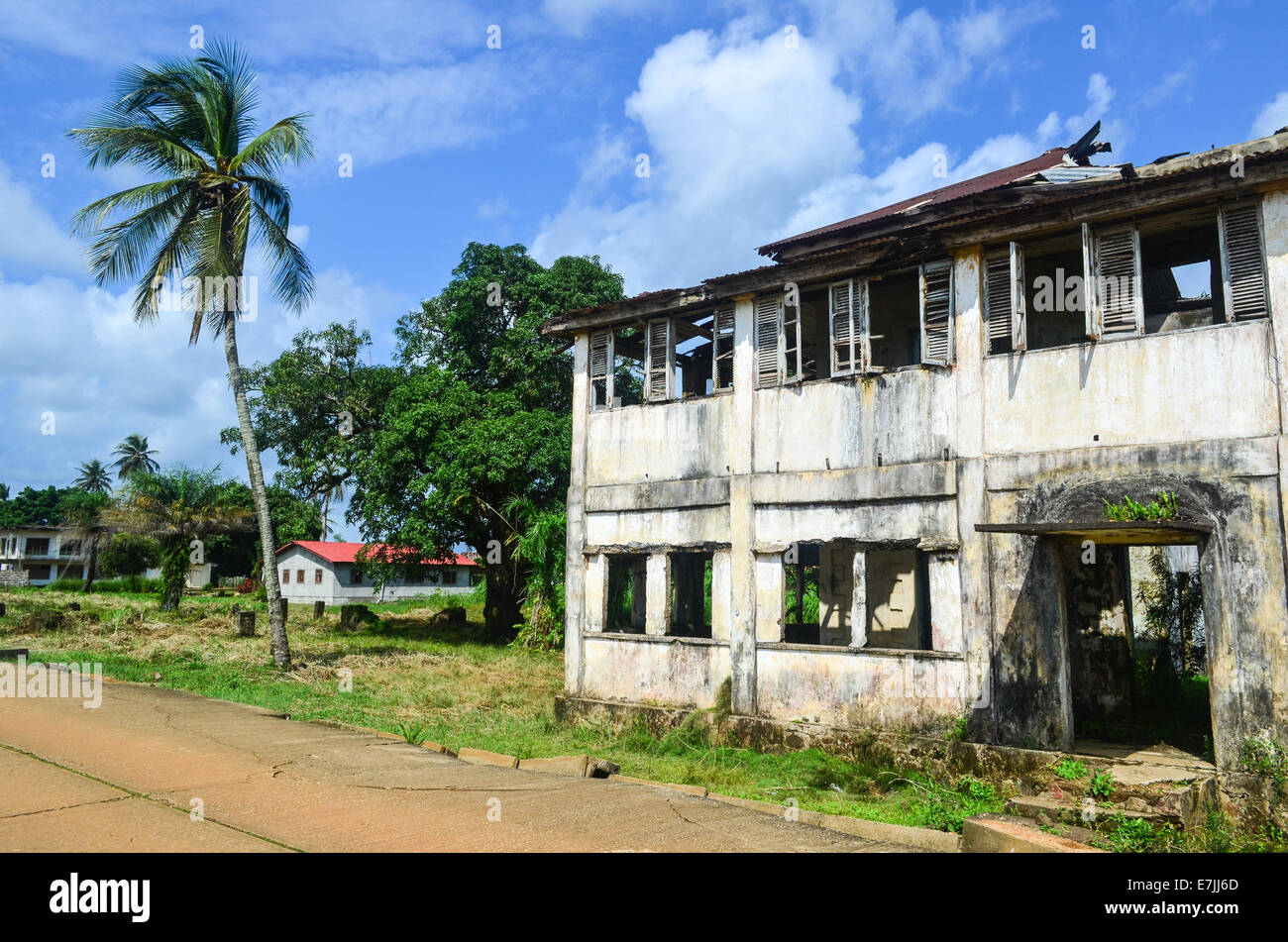 Ruins (from the civil war) and palm trees in Robertsport, a coastal town in Liberia, Africa Stock Photo