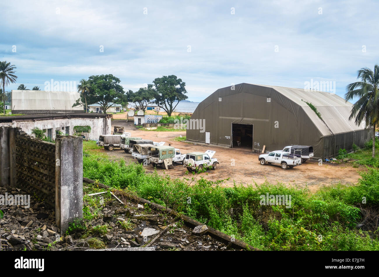 Vehicles and hangar of a UN camp in Monrovia, Liberia, seen from the top of the ruins of Hotel Africa Stock Photo