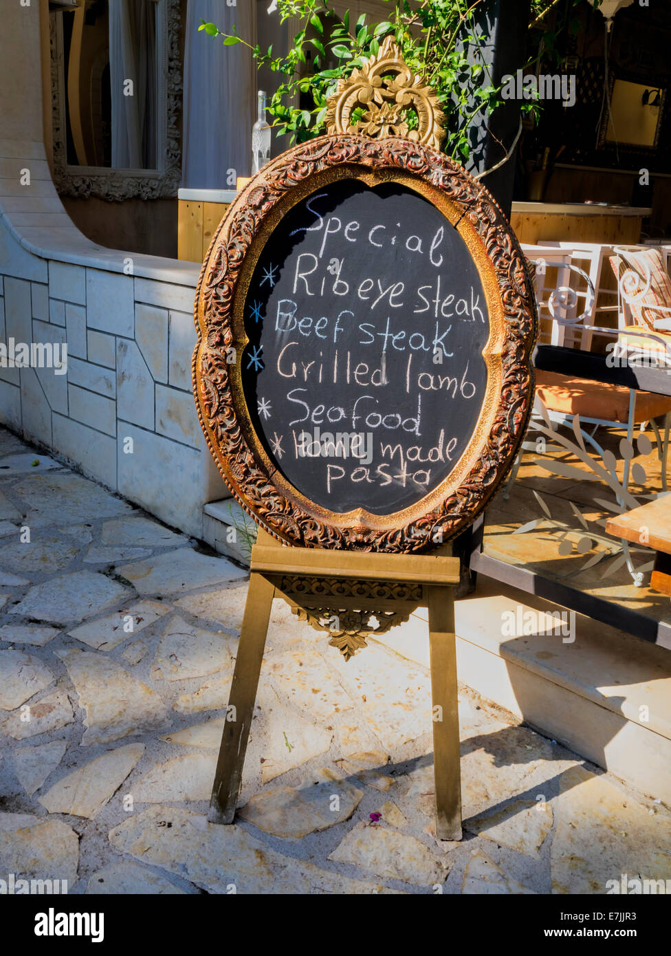 Chalkboard menu outside a restaurant in Greece Stock Photo