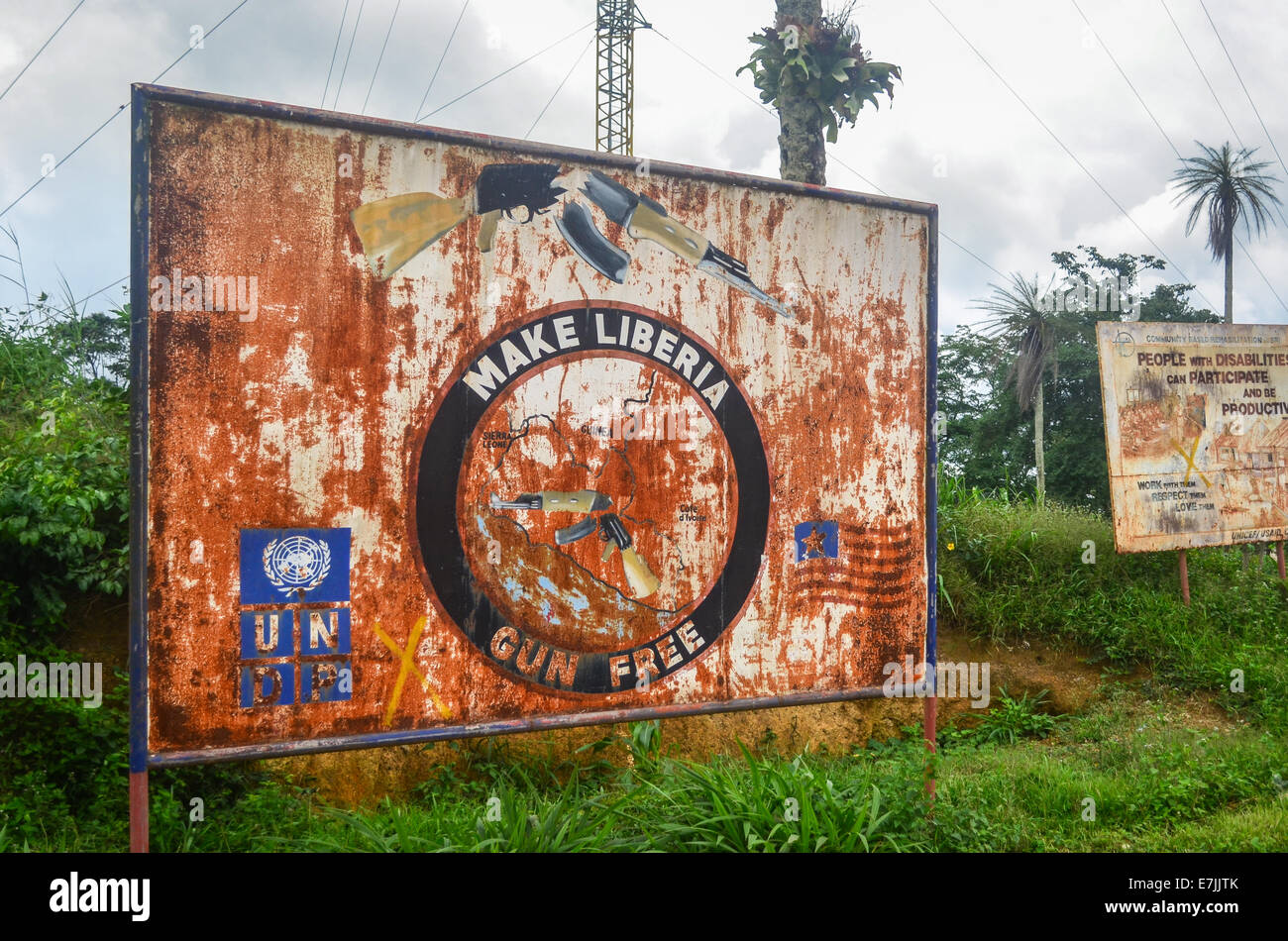 A rusty sign in Liberia reading 'Make Liberia gun free' by UNDP to deal with the civil war Stock Photo