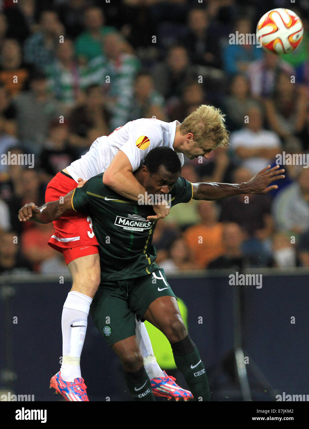 Salzburg, Austria. 18th Sep, 2014.Salzburg's Martin Hinteregger (l) vies for the ball with Celtic's Efe Ambrose during the Europa League soccer match between Red Bull Salzburg vs FC Celtic Glasgow in Salzburg, Austria, 18 September 2014. Credit:  dpa picture alliance/Alamy Live News Stock Photo