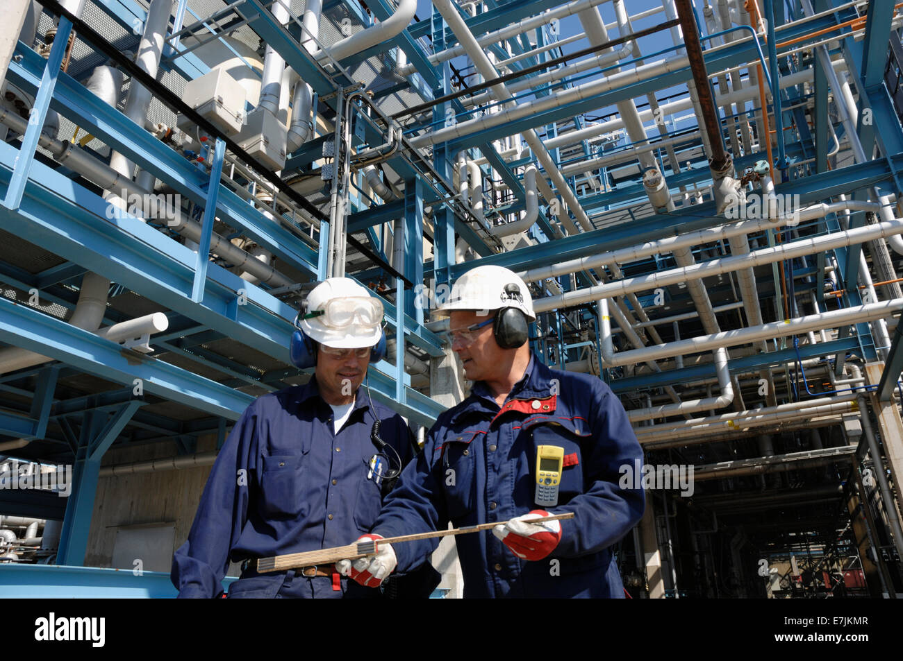 oil and gas workers inside large chemical refinery, oil and gas Stock Photo