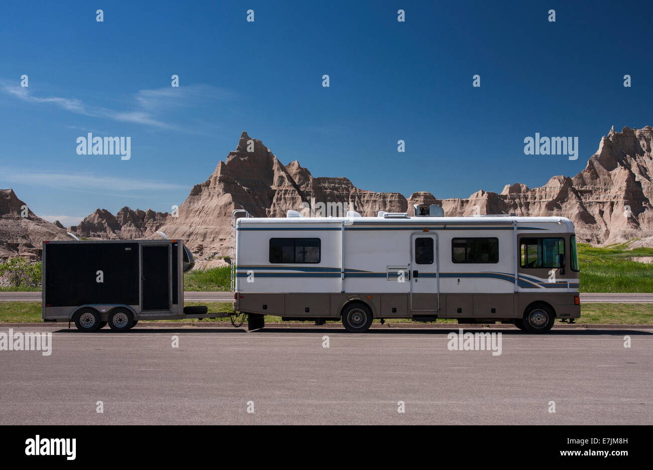 Badlands National Park, Wall, South Dakota, RV parked at Ben Reifel Visitor Center with rock outcrops in the back Stock Photo