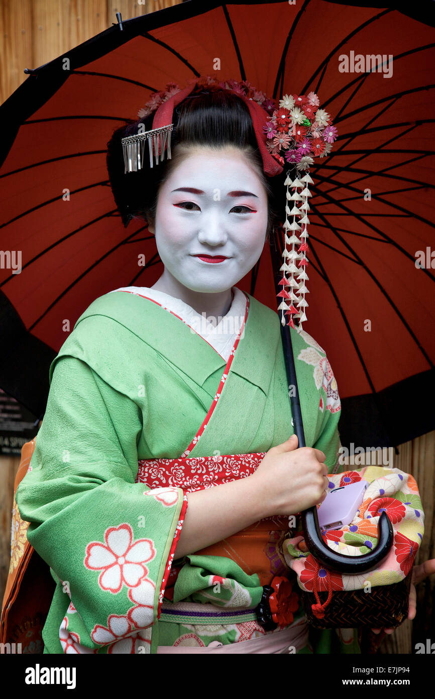 Japanese woman portrait, female beauty, geisha smiling, Gion area, Kyoto, Japan, Asia. Traditional geishas make up and dress Stock Photo