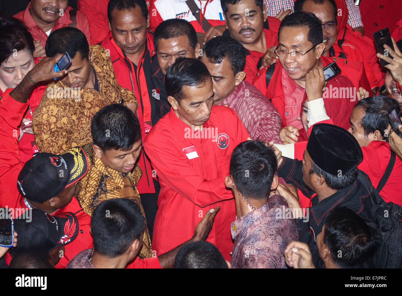 Semarang, Indonesia. 19th September, 2014. Indonesian president-elect Joko Widodo shakes hands with supporters during the 4th national working meeting of PDI-P at Marina Convention Hall in Semarang, Central Java, Indonesia. The national meeting attended by 1,590 party cadres from all over Indonesia and take place from 19-21 September 2014. The meeting is expected to change the 10-year mindset of the PDI-P, as it has switched to being the ruling party from being the opposition party. Credit:  PACIFIC PRESS/Alamy Live News Stock Photo
