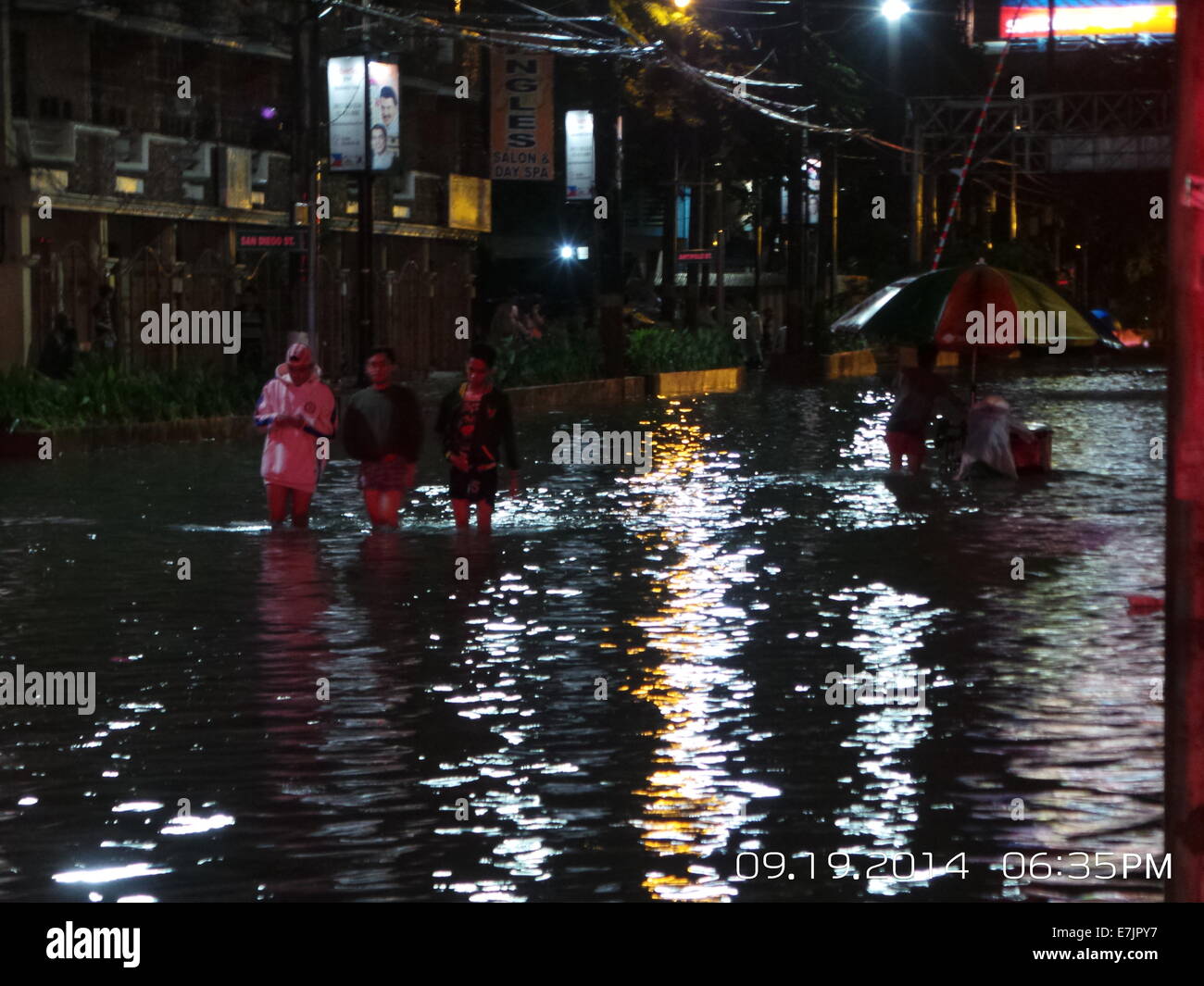 Manila, Philippines. 19 September, 2014. Almost one kilometer of Espana Blvd. is flooded and mostly not passable due to gutter deep flood waters brought by Tropical Storm Fung Wong which is locally known as Mario. Some vehicles and stranded passengers took the guts to traverse the horrendous flood waters along the stretch of Espana Blvd. Its estimated rainfall amount is from 7 – 20 mm per hour(moderate to intense) within the stropical storm’s 350 km diameter. Credit:  Sherbien Dacalanio / Alamy Live News Stock Photo