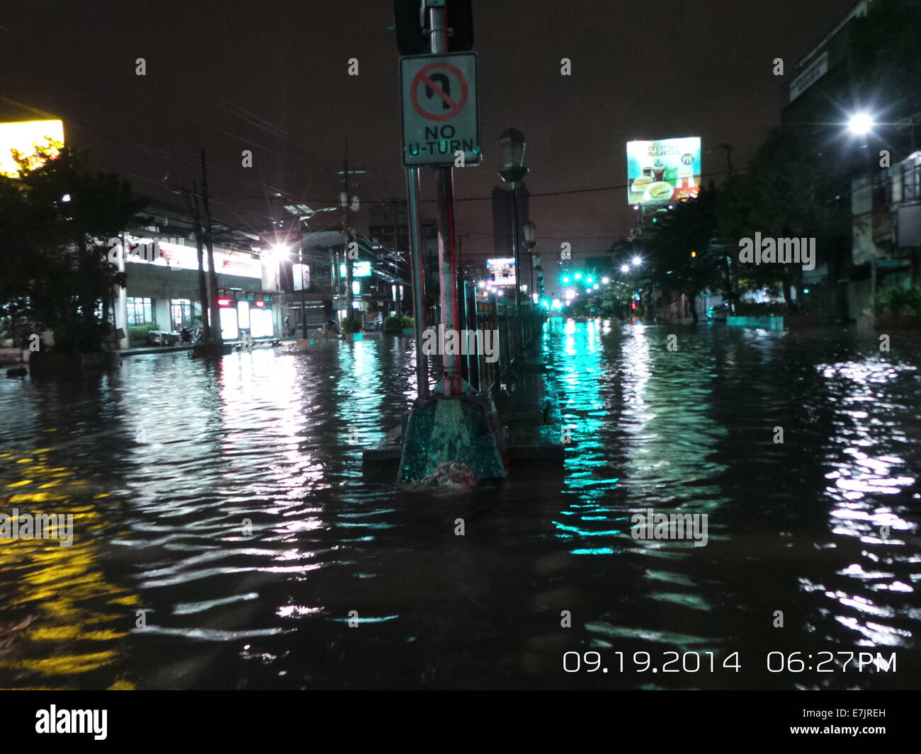 Manila, Philippines. 19 September, 2014. Almost one kilometer of Espana Blvd. is flooded and mostly not passable due to gutter deep flood waters brought by Tropical Storm Fung Wong which is locally known as Mario. Some vehicles and stranded passengers took the guts to traverse the horrendous flood waters along the stretch of Espana Blvd. Its estimated rainfall amount is from 7 – 20 mm per hour(moderate to intense) within the stropical storm’s 350 km diameter. Credit:  Sherbien Dacalanio / Alamy Live News Stock Photo