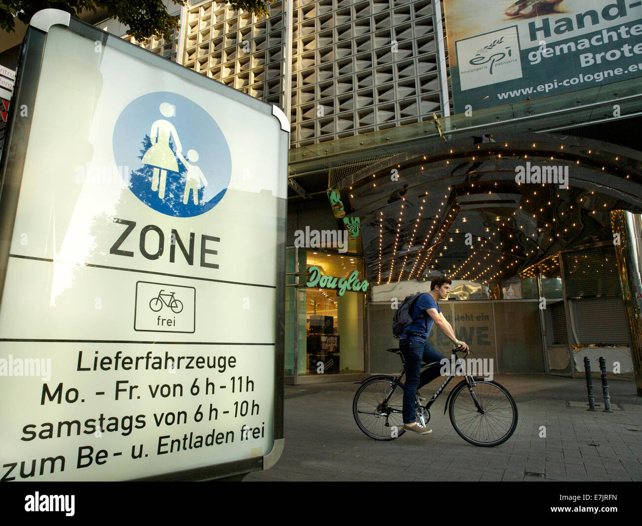Pedestrian zone sign in the city center of Cologne, NRW, Germany, with bicyclist passing Stock Photo