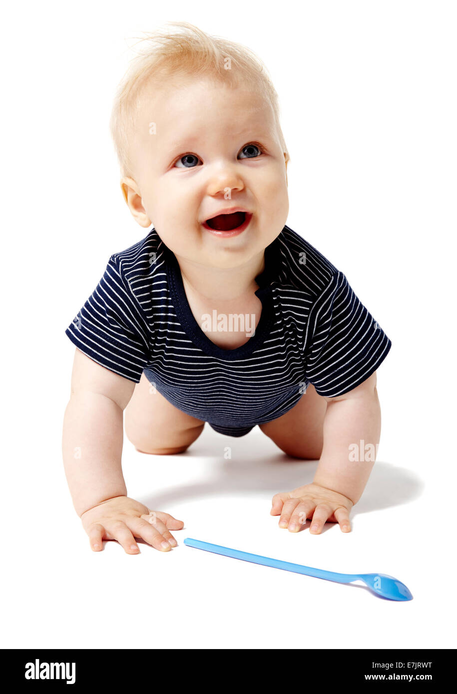 Happy baby crawling on knees and looking up. Stock Photo